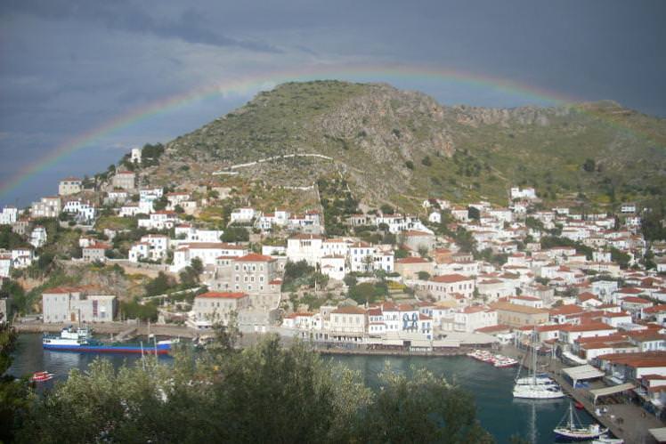 Rainbow over Hydra island’s small harbour. Image by Alexis Averbuck / Lonely Planet