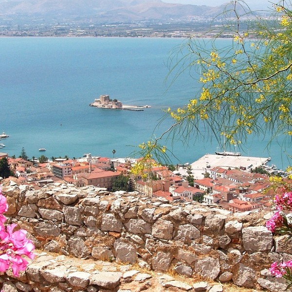 Flowers overlooking a town & bay on the Greek mainland, one of the sights on the ASIT 11 day tour.